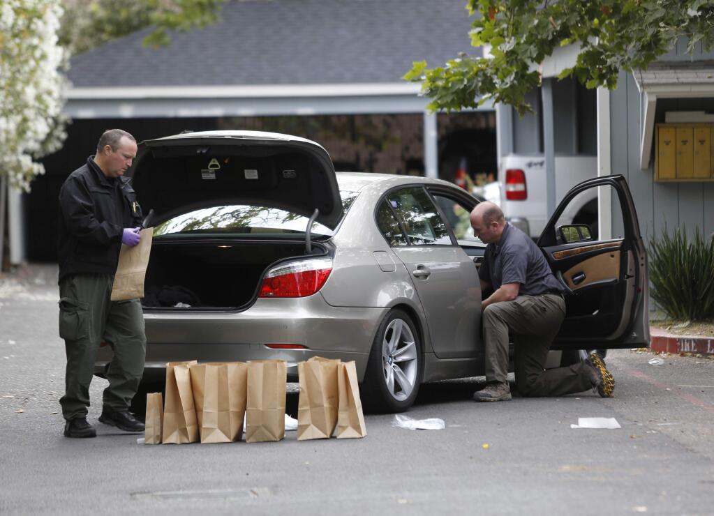 Sonoma County Sheriff deputies and detectives collect evidence from a gang related shooting Monday morning near a Corby Ave apartment complex in Santa Rosa, July 6, 2015. (BETH SCHLANKER/ The Press Democrat)