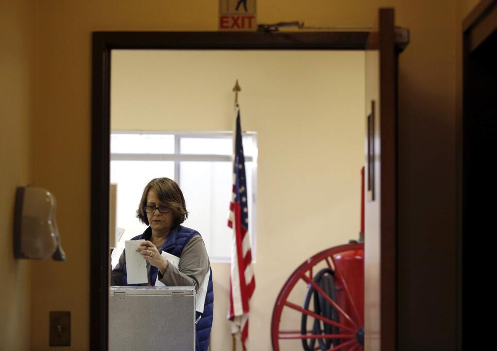 Bridgit Lee casts her ballot at the Rancho Adobe Fire District Penngrove Station in Penngrove on Tuesday, Nov. 4, 2014.(BETH SCHLANKER/ PD FILE)