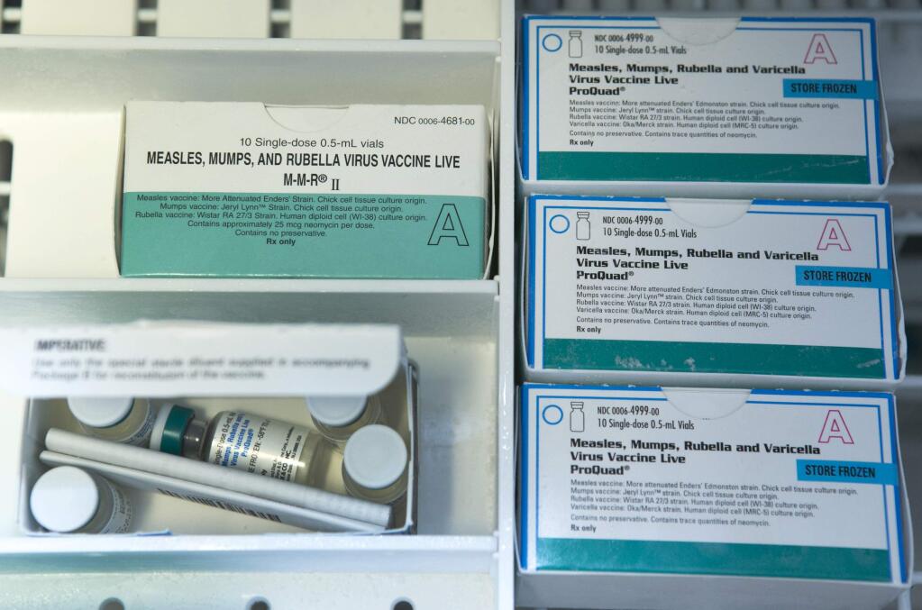 Boxes of single-doses vials of the measles-mumps-rubella virus vaccine live, or MMR vaccine and ProQuad vaccine are kept frozen inside a freezer at the practice of Dr. Charles Goodman in Northridge, Calif., Thursday, Jan. 29, 2015. (AP Photo/Damian Dovarganes)