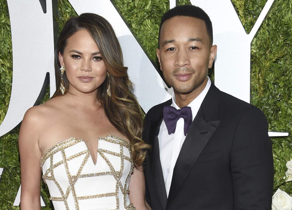 FILE - In this June 11, 2017 file photo, Chrissy Teigen, left and John Legend arrive at the 71st annual Tony Awards in New York. (Photo by Evan Agostini/Invision/AP, File)