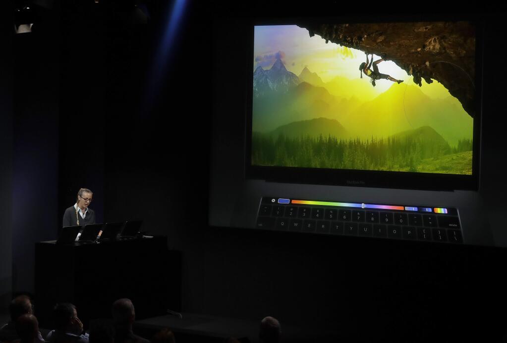 Bradee Evans, experience design manager at Adobe Photoshop, gives a demonstration of using Touch Bar during an announcement of new Apple products Thursday, Oct. 27, 2016, in Cupertino, Calif. (AP Photo/Marcio Jose Sanchez)