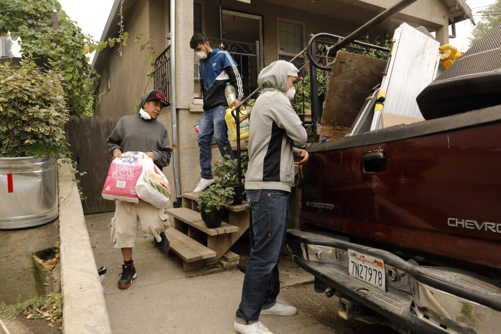Residents load up their truck as they evacuate on Wednesday, October 11, 2017 in Boyes Hot Springs, California . (BETH SCHLANKER/The Press Democrat)
