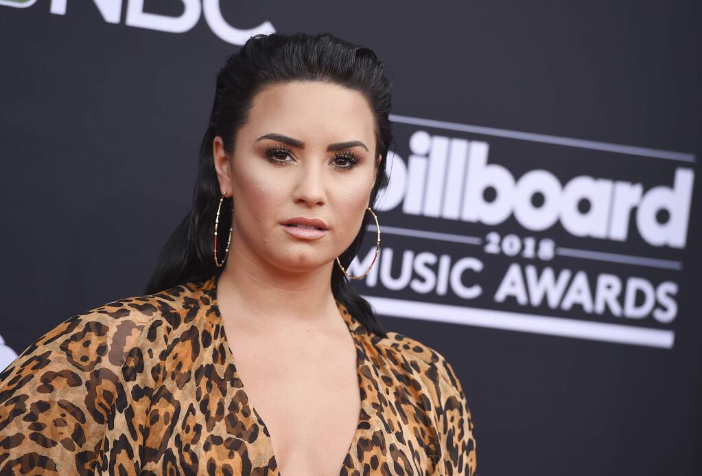 FILE - In this May 20, 2018, file photo, Demi Lovato arrives at the Billboard Music Awards at the MGM Grand Garden Arena in Las Vegas. Lovato‚Äôs mother said in an interview aired on Newsmax TV, the singer is ‚Äúdoing really well‚Äù nearly two months after being hospitalized for a drug overdose. (Photo by Jordan Strauss/Invision/AP, File)