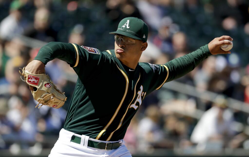 Oakland Athletics starting pitcher Jesus Luzardo throws against the Chicago White Sox during the third inning in Mesa, Ariz., Sunday, March 18, 2018. (AP Photo/Chris Carlson)
