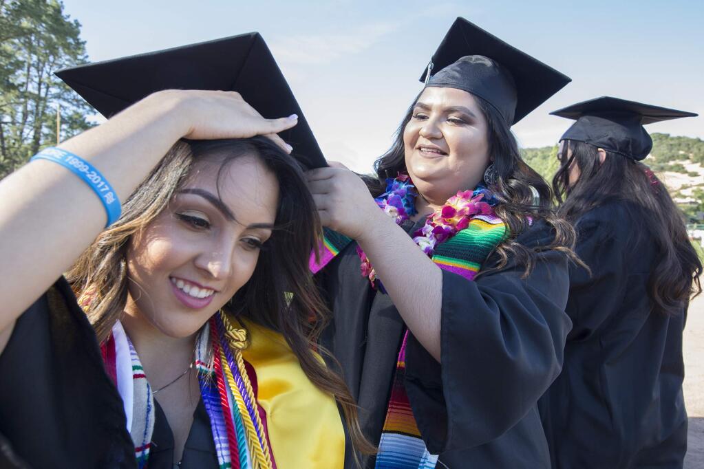 Ariana Lopez, 17, gets some help adjusting her cap from Alexandra Rodriguez, 17. Sonoma Valley High School's 2017 graduation ceremony took place on Friday, June 2, at Arnold Field. (Photo by Robbi Pengelly/Index-Tribune)