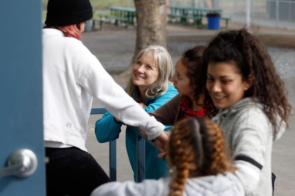 Humanities teacher Julie Stolze, second from left, talks with some of her students during a break at Stony Point Academy, in Santa Rosa, California, on Thursday, March 8, 2018. (Alvin Jornada / The Press Democrat)