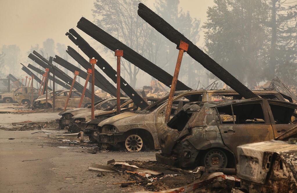 A row of burned cars line what used to be the carport at Estancia Apartment Homes, along Old Redwood Highway, in Santa Rosa on Tuesday, October 10, 2017. (Christopher Chung/ The Press Democrat)