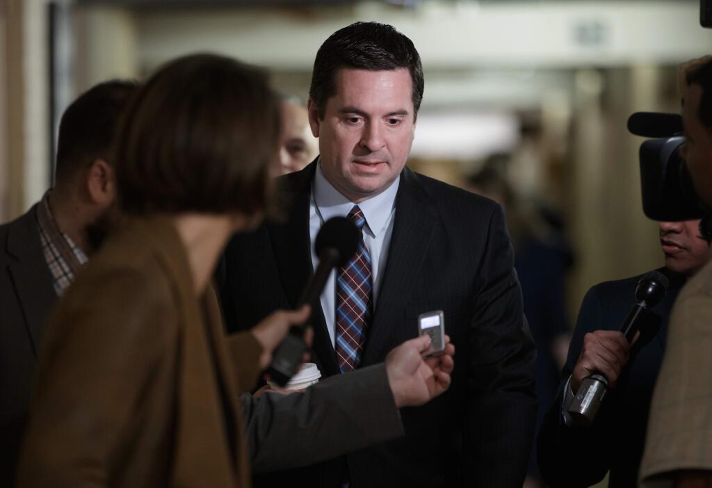 FILE - In this March 28, 2017 file photo, House Intelligence Committee Chairman Rep. Devin Nunes, R-Calif. is pursued by reporters on Capitol Hill in Washington. Nunes says he's temporarily stepping aside from Russia probe amid ethics accusations. (AP Photo/J. Scott Applewhite, File)