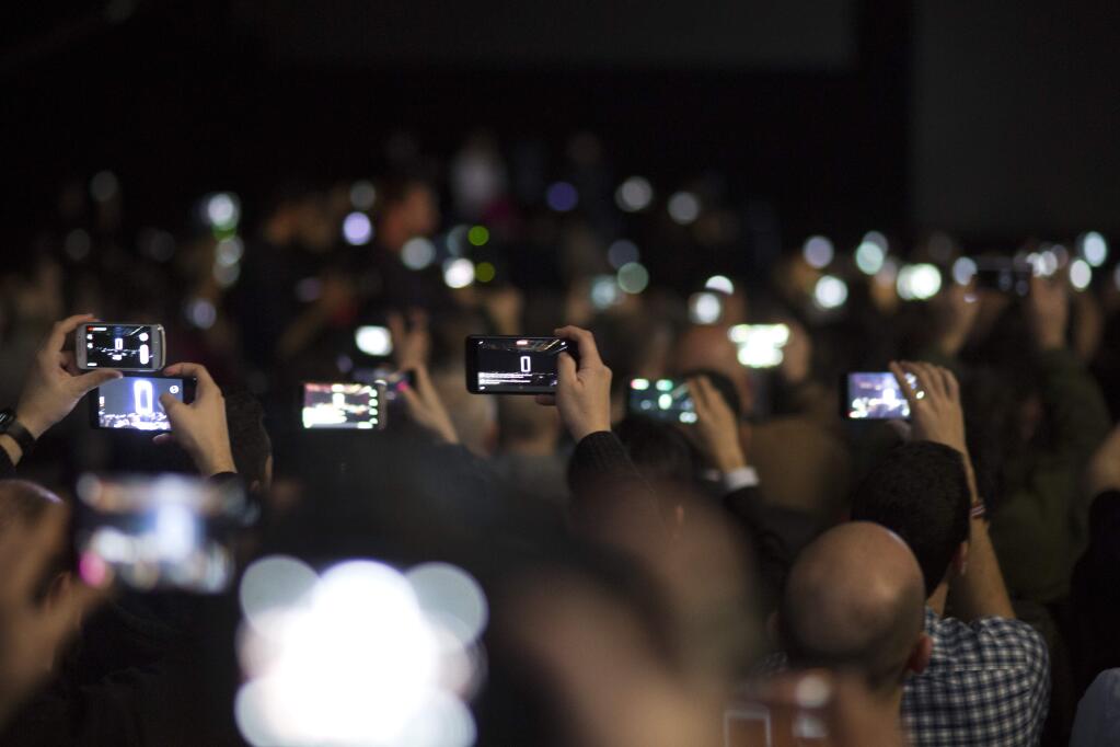 Attendances use their phones to take images of the new G6 unveiled by LG as its next phone, ahead of Monday's opening of the Mobile World Congress wireless show in Barcelona, Spain, Sunday, Feb. 26, 2017. South Korean electronics company LG has launched the world's first smartphone with a 18:9 aspect ratio at the Mobile World Congress (MWC) technology show in Barcelona.The Mobile World Congress will be held 27 Feb. to 2 March. (AP Photo/Emilio Morenatti)
