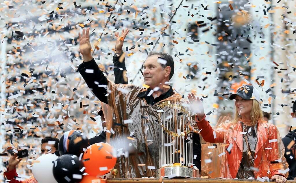 Manager Bruce Bochy rides in Friday's parade with MLB's Commissioner's Trophy, given for three of the past five years to his Giants. (Kent Porter / The Press Democrat)