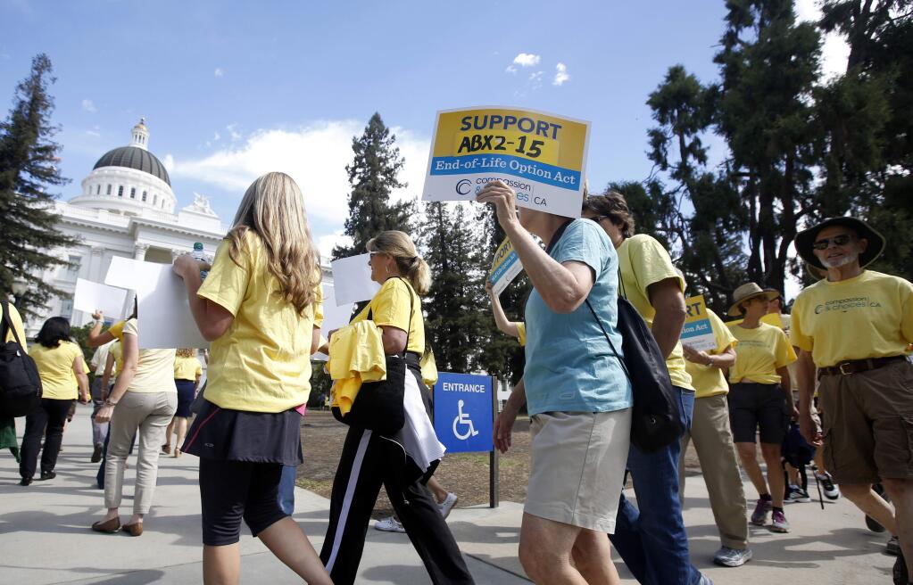 FILE - In this Sept. 24, 2015 file photo supporters of a measure to allow terminally ill people to end their own life march at the Capitol in Sacramento, Calif. California health officials say 374 terminally ill people took drugs to end their lives in 2017, the first full year after a law making the option legal took effect. They added, 577 people received aid-in-dying drugs in 2017, but not everyone used them. (AP Photo/Rich Pedroncelli, File)