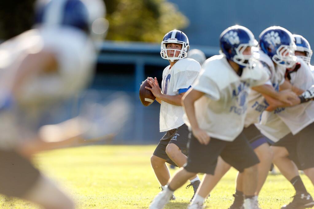 Analy quarterback Jack Newman, center, settles in the pocket to make a pass during varsity football practice at Analy High School in Sebastopol, California on Thursday, October 6, 2016. (Alvin Jornada / The Press Democrat)