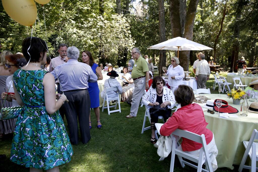 Guests mingle under a canopy of trees at the historic Pythian House in 2014. (BETH SCHLANKER/ PD FILE)