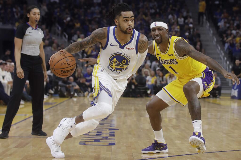 Golden State Warriors guard D'Angelo Russell (0) dribbles past Los Angeles Lakers guard Kentavious Caldwell-Pope (1) during the first half of a preseason NBA basketball game in San Francisco, Saturday, Oct. 5, 2019. (AP Photo/Jeff Chiu)