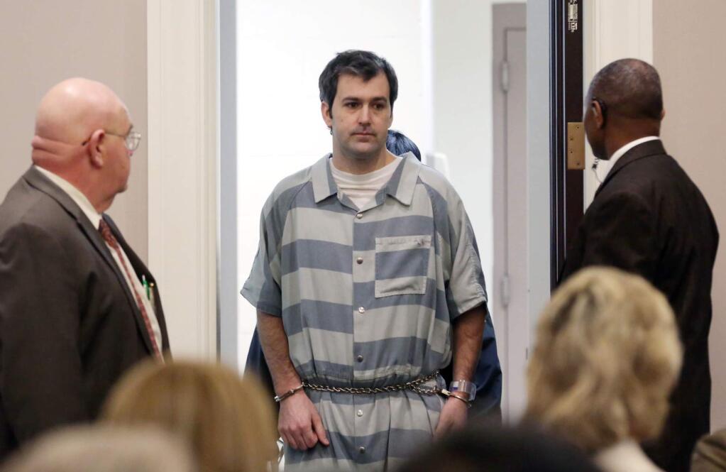 FILE - In a Thursday, Sept. 10, 2015 file photo, former North Charleston police office Michael Slager, is lead into court, in Charleston, S.C. A federal judge will decide whether Slager, charged with murder in the shooting death of an unarmed black motorist, can remain free on bond. An indictment unsealed Wednesday, May 11, 2016, shows that Slager is charged with violating Walter Scott's civil rights and two other federal charges. (Grace Beahm/The Post And Courier via AP)