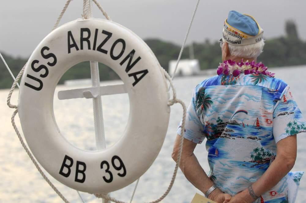 A survivor of the 1941 attack on Pearl Harbor overlooks the water near a replica lifesaver during the 65th anniversary ceremony in Pearl Harbor, Hawaii, Thursday, Dec. 7, 2006. (AP Photo/Lucy Pemoni)