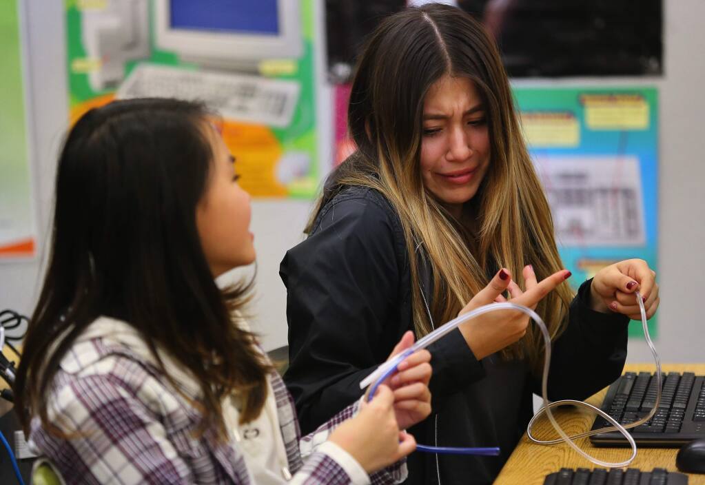 Emily Torres, right, and Amy Tang look at a nasogastric tube during a Gun Information for Teens presentation at Piner High School, in Santa Rosa, on Wednesday, February 3, 2016. (Christopher Chung/ The Press Democrat)