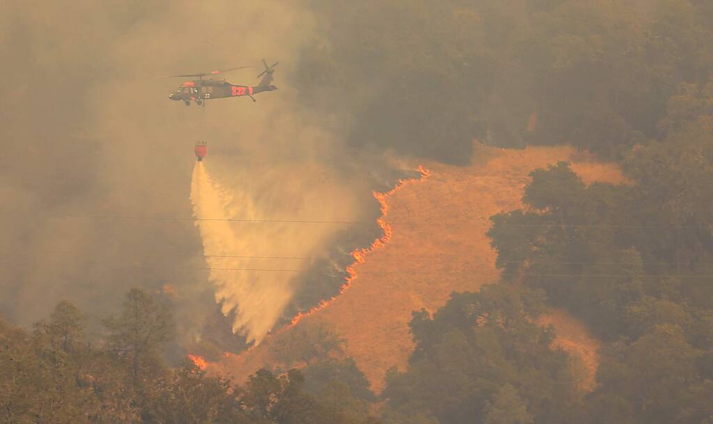 The Air National Guard makes a drop on the Pocket fire in Geyserville, Thursday Oct. 12, 2017. (Kent Porter / Press Democrat) 2017