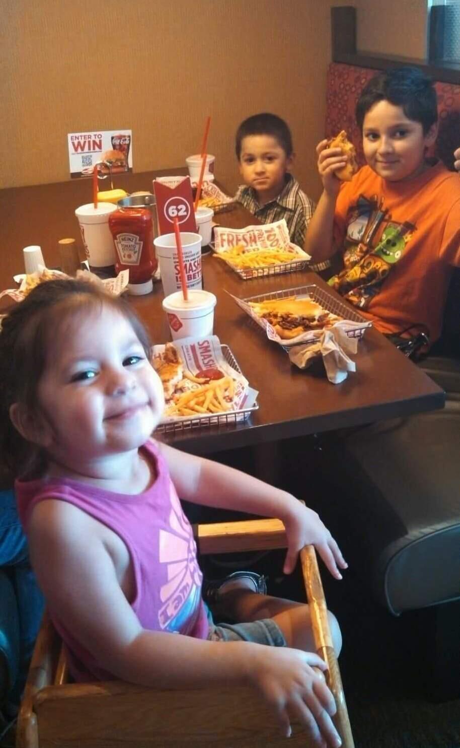 This 2014 photo provided by Virginia Saldivar shows her grandchildren Daisy, from left, Xavier and Dominic Saldivar, three of the four children presumed dead after their van sank into Greens Bayou on Houston's eastside. Virginia Saldivar says she presumes six members of a family, including four of her grandchildren, have died after their van was carried by a strong current into the bayou and sank. (Virginia Saldivar via AP)