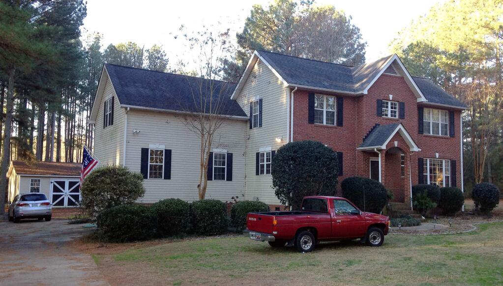 Cars are parked at a home in York, S.C. on Tuesday, Jan. 16, 2018, where multiple deputies responding to a domestic violence call were shot and wounded. State Law Enforcement Division spokesman Thom Berry said Christian Thomas McCall is the man officers think shot and wounded the officers early Tuesday. (AP Photo/Jeffrey S. Collins)