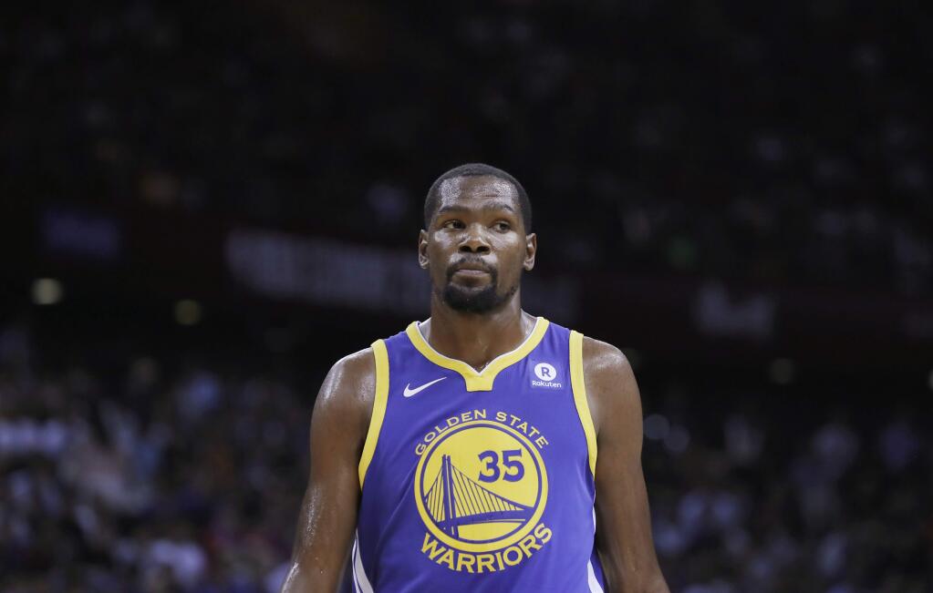 Golden State Warriors' Kevin Durant looks on during the basketball match of the 2017 NBA Global Games against Minnesota Timberwolves in Shenzhen, south China's Guangdong province, Thursday, Oct. 5, 2017. (AP Photo/Kin Cheung)