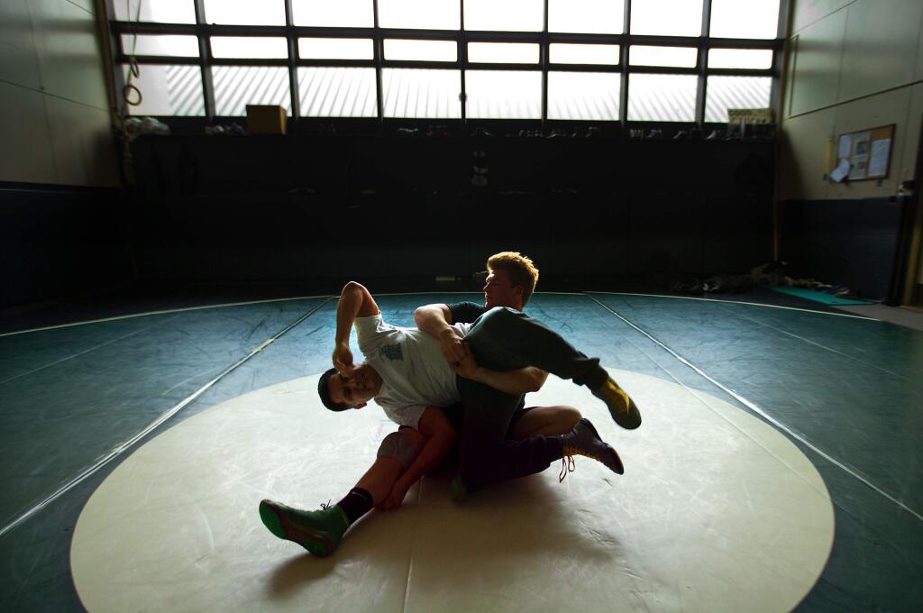 Sonoma Valley junior wrestler Tyler Winslow practices with coach Nico Saldana for the state wrestling tournament this week. Tyler's father, Deets Winslow, was the wrestling coach at Sonoma Valley for 20 years before he died in a tragic boat accident nearly four years ago. (photo by John Burgess/The Press Democrat)