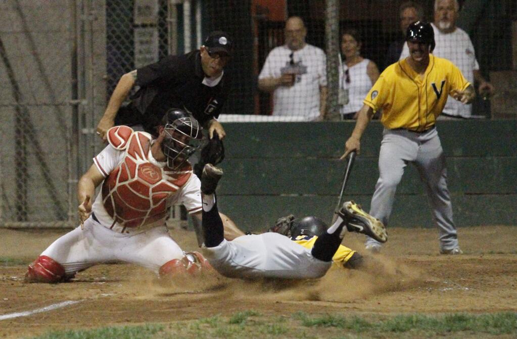 Photos by Bill Hoban/Index-TribuneStompers' catcher Issac Wenrich puts a tag on a sliding Vallejo runner in Friday night's Pacific Association championship game. The Admirals got off to a 9-1 lead before the Stompers cut the margin to a single run.