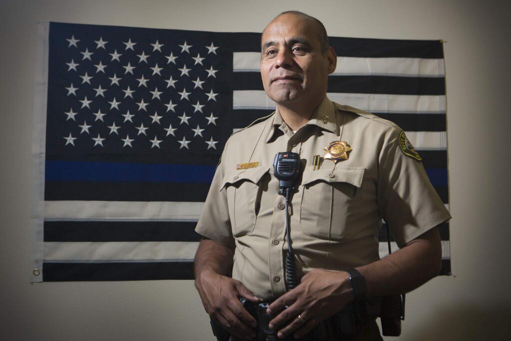 Sonoma Police Chief Orlando Rodriguez with the Blue Lives Matter flag, which symbolizes support for law enforcement. (Photo by Robbi Pengelly/Index-Tribune)