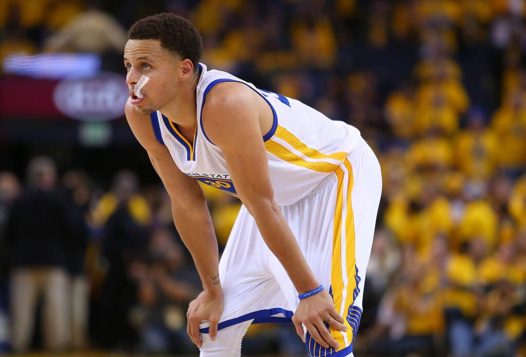 Golden State Warriors guard Stephen Curry watches the Memphis Grizzlies shoot free throws near the end of the during Game 2 of the Western Conference semifinals at Oracle Arena in Oakland on Tuesday, May 5, 2015. (Christopher Chung / The Press Democrat)