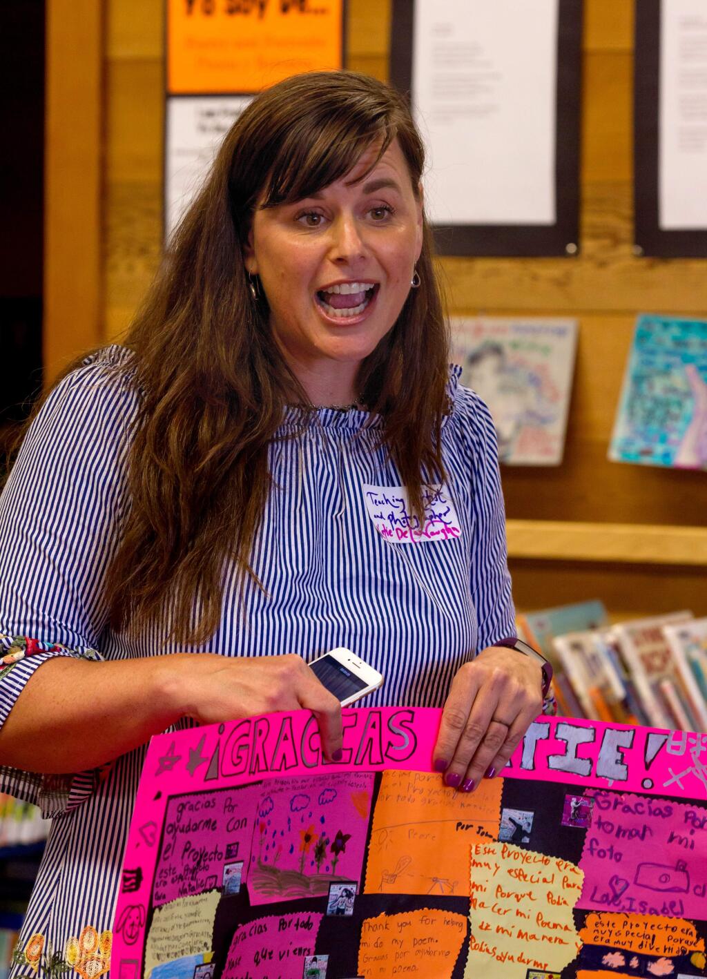 Katie Dela Vaughn, a teaching artist, holds a gift saying 'Gracias Katie' that she received from the the second graders from Loma Vista Immersion Academy at Petaluma Regional Library, in Petaluma, Calif., on Wednesday, May 9, 2018. (Photo by Darryl Bush / For The Press Democrat)