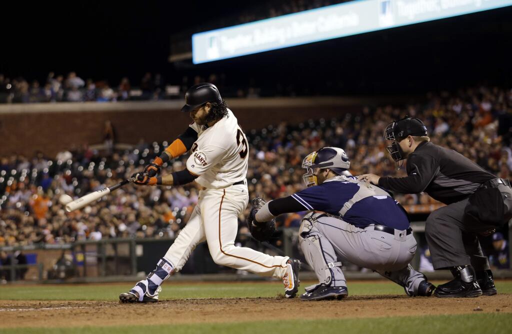San Francisco Giants' Brandon Crawford drives in three runs with a bases-loaded triple during the eighth inning of a baseball game against the San Diego Padres Tuesday, May 24, 2016, in San Francisco. (AP Photo/Marcio Jose Sanchez)