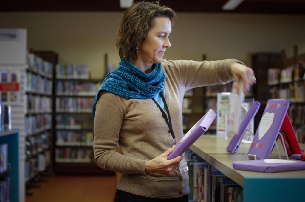 Diana Spaulding, the Teen Librarian, hopes that some of the tax dollars going to library maintenance can be used to make improvements to the teen section, creating a closed-off separate enclosure. (CRISSY PASCUAL/ARGUS-COURIER STAFF)