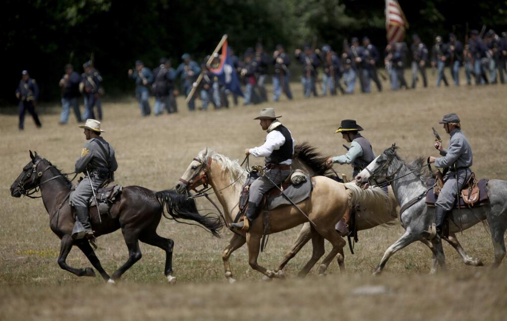 Confederate Cavalry reenactors charge into a mock battle during the Civil War Days on Sunday, July 19, 2015 in Duncans Mills, California . (BETH SCHLANKER/ The Press Democrat)