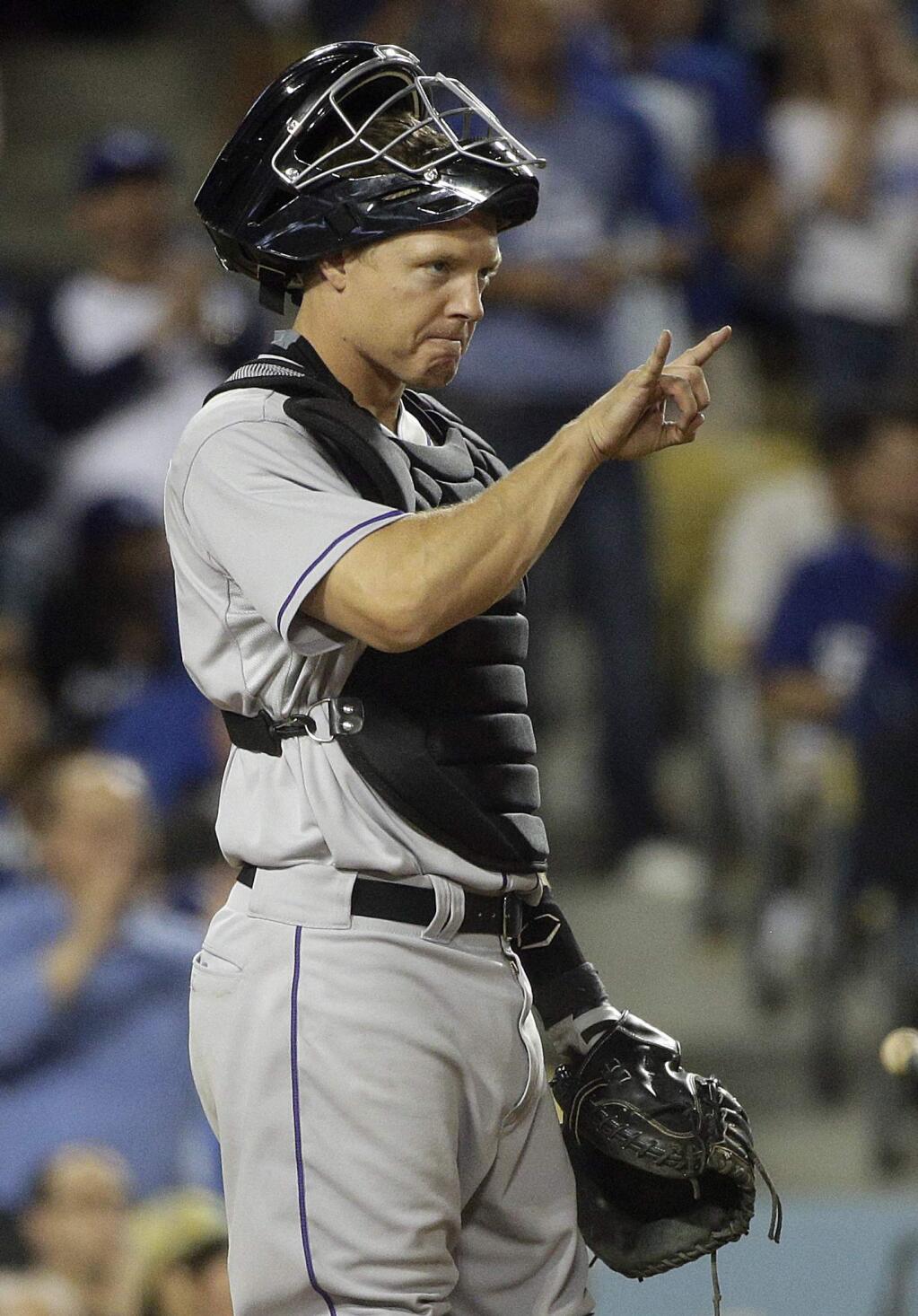 In this April 17, 2015, file photo, Colorado Rockies catcher Nick Hundley signals to starting pitcher Christian Friedrich during the seventh inning against the Los Angeles Dodgers in Los Angeles. (AP Photo/Jae C. Hong, File)