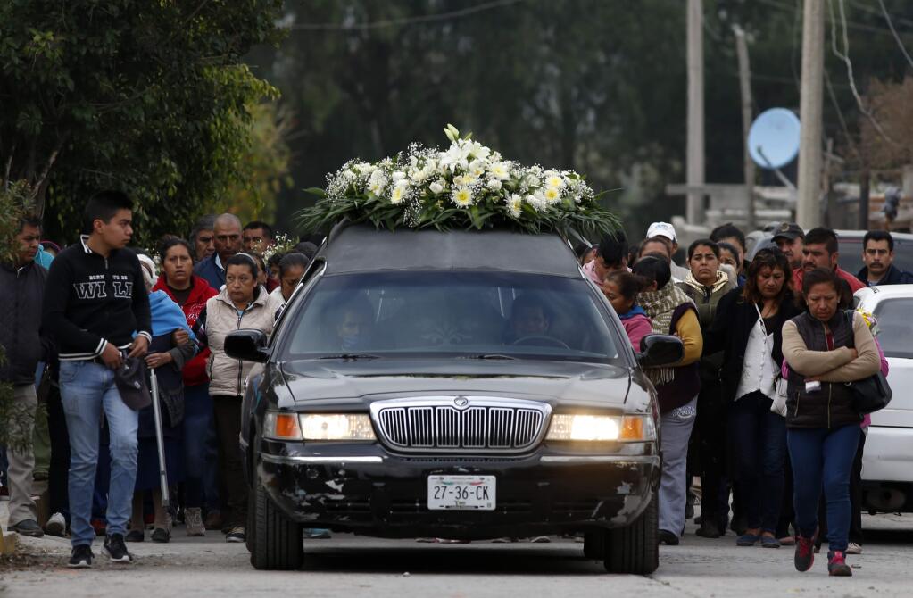 The relatives of Gerardo Preciado Cornejo, who died when a gas pipeline exploded, hold his funeral procession in the village of Tlahuelilpan, Mexico, Sunday Jan. 20, 2019. A massive fireball that engulfed locals scooping up fuel spilling from a pipeline ruptured by thieves in central Mexico killed dozens of people and badly burned dozens more on Jan. 18. (AP Photo/Claudio Cruz)