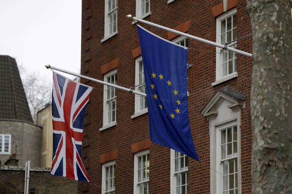 A European and British Union flags hang outside Europe House, the European Parliament's British offices in London, Monday, March 20, 2017. Britain's government will begin the process of leaving the European Union on March 29, starting the clock on the two years in which to complete the most important negotiation for a generation. (AP Photo/Matt Dunham)