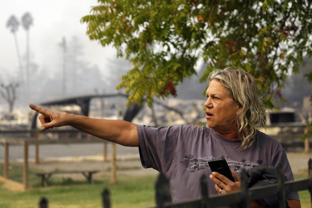 Jim Cook, manager of the Journey's End mobile home park, points to damage on the property Monday, Oct. 9, 2017, in Santa Rosa, Calif. Wildfires whipped by powerful winds swept through Northern California, sending residents on a headlong flight to safety through smoke and flames as homes burned. (AP Photo/Ben Margot)