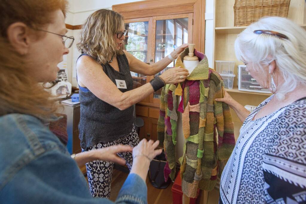 At the opening of the Fiber Arts Center in the Sonoma Community Center, Lori Goldman explained how to make a knitted woven jacket. (Photo by Robbi Pengelly/Index-TribuneO