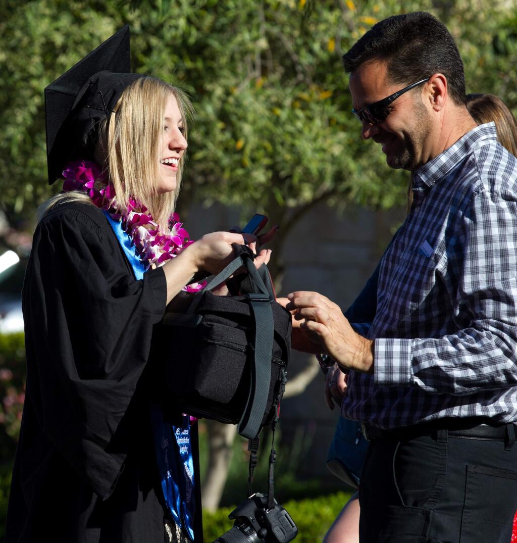 Alexis Simmons, graduating in Business Marketing, laughs with her father, Layne Simmons, of Fortuna, Calif., as they prepare for the 2017 Commencement for the School of Business and Economics at Sonoma State University, in Rohnert Park, Calif., on Saturday, May 20, 2017. (Photo by Darryl Bush / For The Press Democrat)