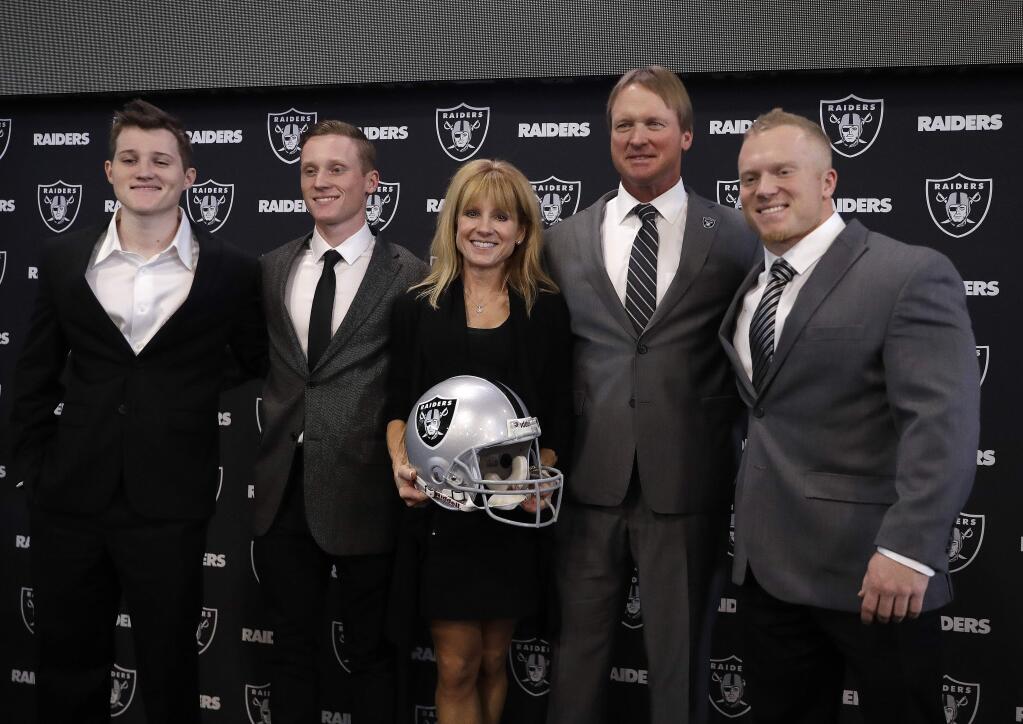Oakland Raiders head coach Jon Gruden, second from right, poses for photographs with his family after a press conference Tuesday, Jan. 9, 2018, in Alameda. (AP Photo/Marcio Jose Sanchez)