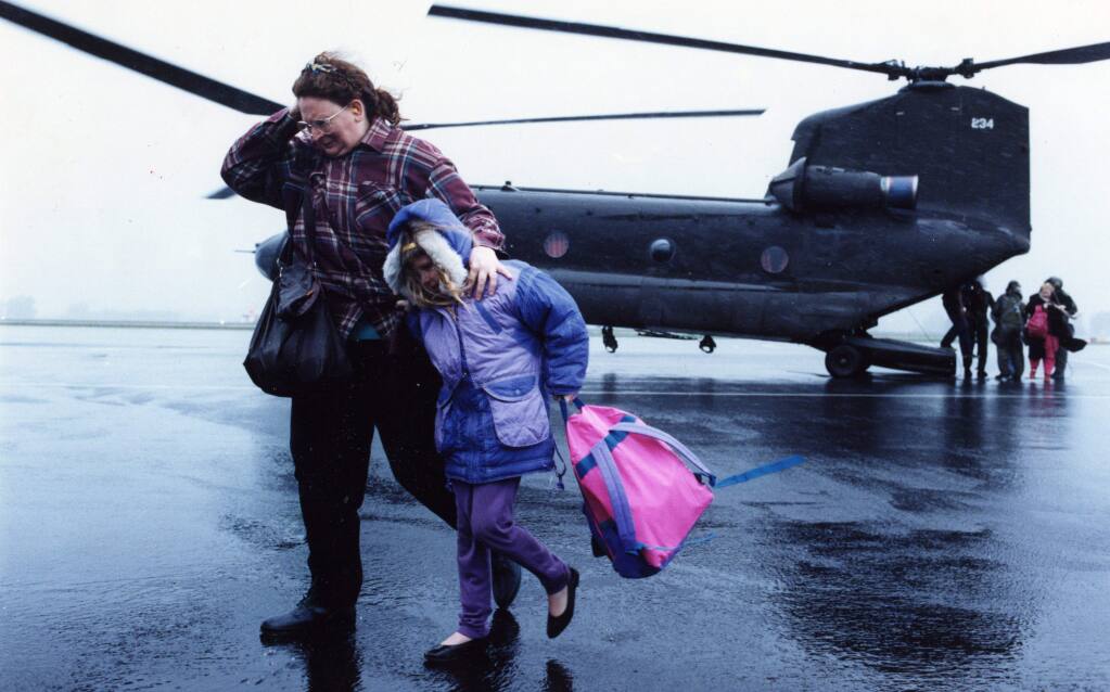 Families are airlifted to safety during the Russian River flood in January of 1995. (Press Democrat Archives)