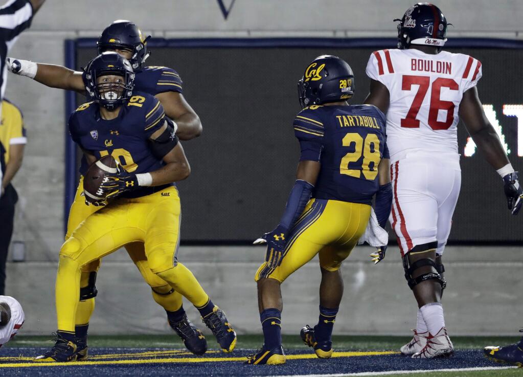 California linebacker Cameron Goode, left, celebrates in the end zone after an interception for a touchdown during the second half of an NCAA college football game against Mississippi Saturday, Sept. 16, 2017, in Berkeley, Calif. (AP Photo/Marcio Jose Sanchez)