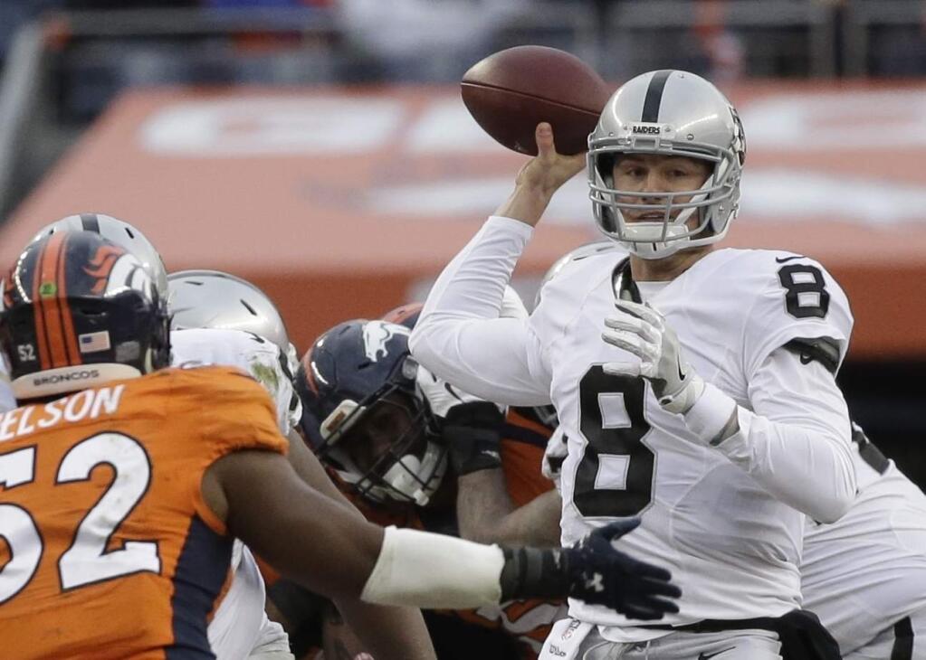 In this Sunday, Jan. 1, 2017, photo, Oakland Raiders quarterback Connor Cook passes against the Denver Broncos in the first half in Denver. (AP Photo/Jack Dempsey)