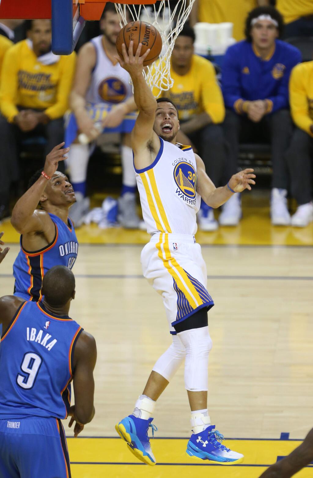 Golden State Warriors' Stephen Curry scores a basket against Oklahoma City Thunder's Russell Westbrook, during their game in Oakland on Monday, May 30, 2016. (Christopher Chung/ The Press Democrat)