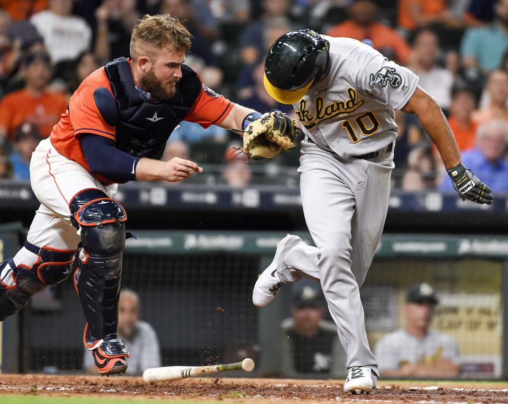 The Oakland Athletics' Marcus Semien is tagged out by Houston Astros catcher Max Stassi after a dropped third strike during the ninth inning Friday, Aug. 18, 2017, in Houston. (AP Photo/Eric Christian Smith)