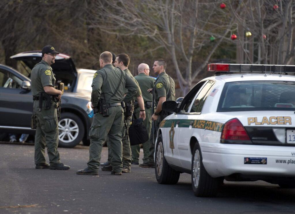 Placer County sheriff's deputies gather near a home on Kemper Oaks Court where a man was shot in his home in Auburn on Sunday, Dec. 21, 2014 in Auburn, Calif. (AP Photo/The Sacramento Bee, Randy Pench)