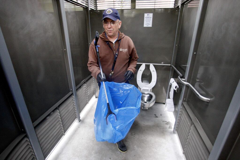 FILE - In this April 12, 2012, file photo, Rodney Haven, of Clean and Safe, cleans the interior of a Portland Loo in Portland, Ore. The city of Portland has intensified its efforts to market its patented Portland Loo, a solar-powered, 24-hour--a-day outdoor public restroom developed to give urbanites relief while warding off junkies, prostitutes and graffiti artists. The city has sold one loo to Victoria, British Columbia and hopes contracting with agents who get 10 percent of the sales will help it take in more cash. U-T San Diego reports that costs for two Portland Loos ballooned because they don't meet California electrical, seismic and other standards. They are being installed in downtown locations where connecting to sewer and water lines is difficult. San Diego anticipates spending $560,000, compared to an initial estimate of $215,000. (AP Photo/Rick Bowmer, File)