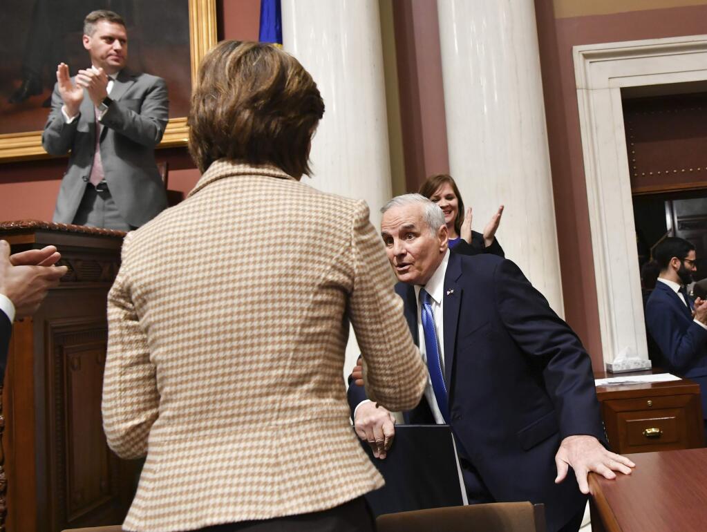 Minnesota Gov. Mark Dayton stumbles as he takes to the podium to begin his State of the State address in St. Paul, Minn., Monday, Jan. 23, 2017. House Speaker Kurt Daudt said minutes after the incident that Dayton was 'up and about' and that the governor would be OK. (Glen Stubbe/Star Tribune via AP)