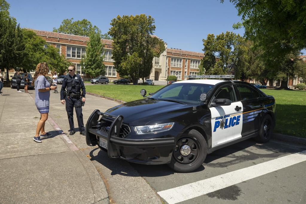 A concerned parent talks with a Santa Rosa police officer blocking the entrance to Santa Rosa High School on Friday, May 31, 2019. The school was locked down after a student brought a gun onto the campus. (JOHN BURGESS/ PD)