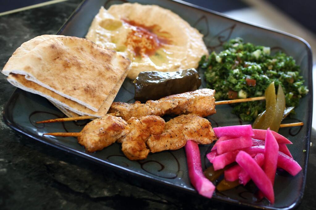 Chicken Kabob plate including hummus, tabouli and pita bread served at King Falafel in Sebastopol, Tuesday, March 31, 2015. Also pictured on plate is a Dolmas, center. (CRISTA JEREMIASON / The Press Democrat)